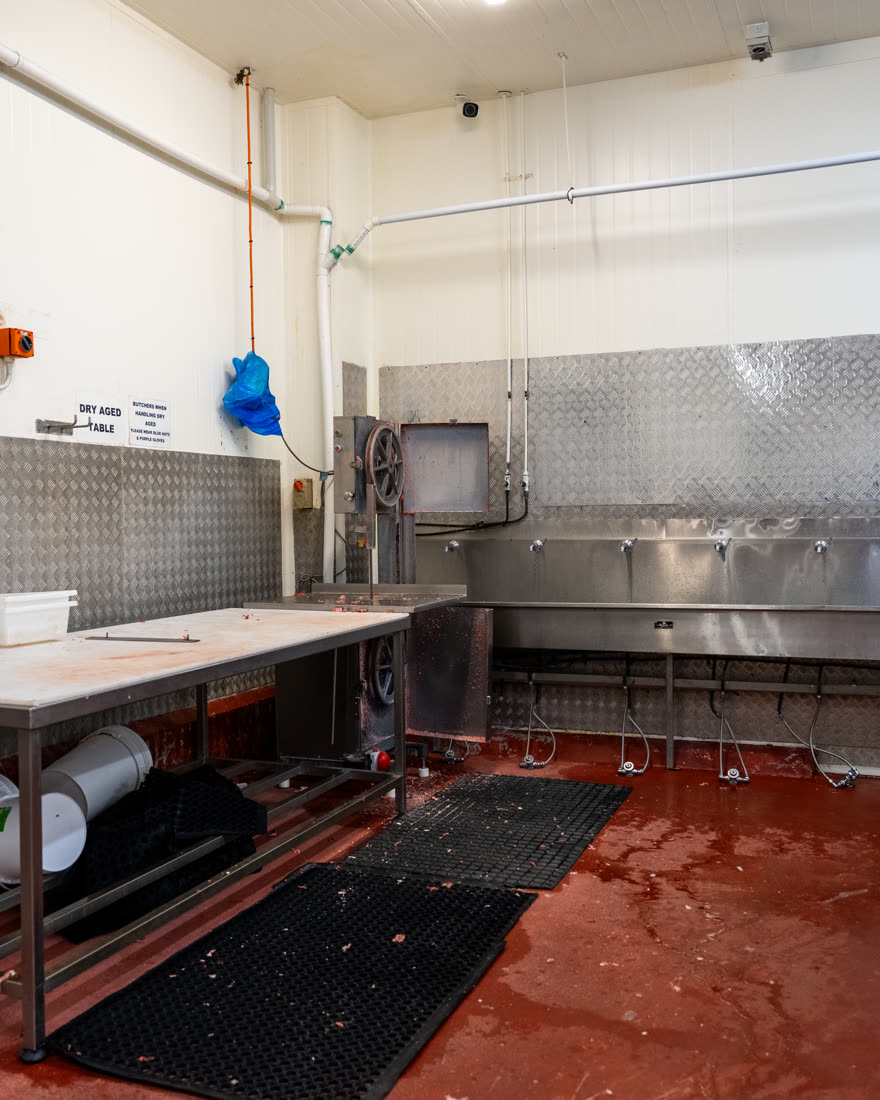 Food production room with soiled floors and benches before sanitation