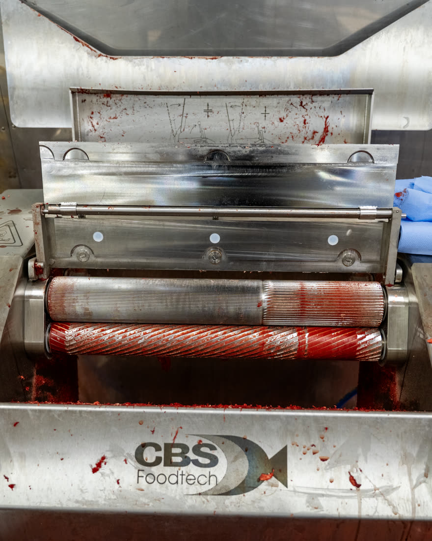 Close-up of processing rollers carrying heavy product residue